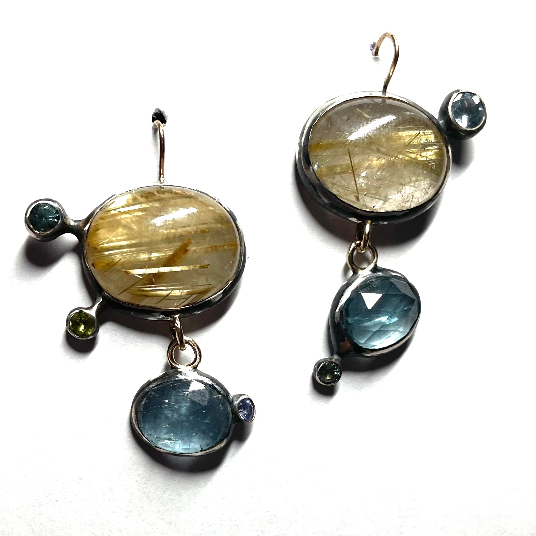 Mismatched Asymmetric Rutilated Quartz and Blue Kyanite Dangle Earrings — Gold Rutilated Quartz is contrasting with blue Kyanite and accented with colred sapphires, all set in oxidized silver with affied 14K gold earwire