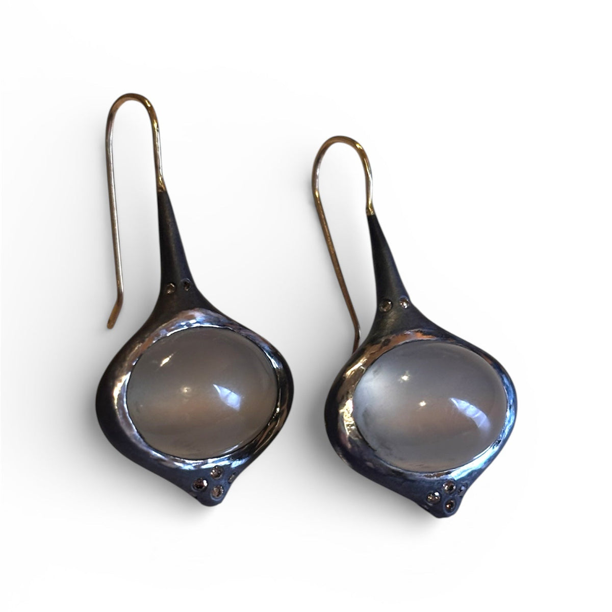 Grey Oval Moonstone Earrings with Brown Diamond Accents — Oval grey Moonstone cabochons are set in silver, featuring 14k gold affixed earwire, brown diamond accents on top and bottom