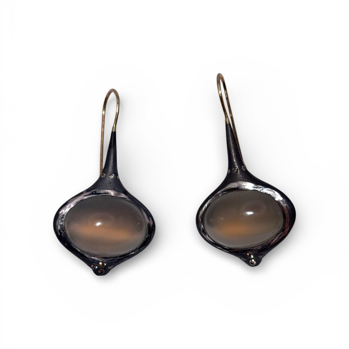 Detail view of Grey Oval Moonstone Earrings with Brown Diamond Accents — Oval grey Moonstone cabochons are set in silver, featuring 14k gold affixed earwire, brown diamond accents on top and bottom