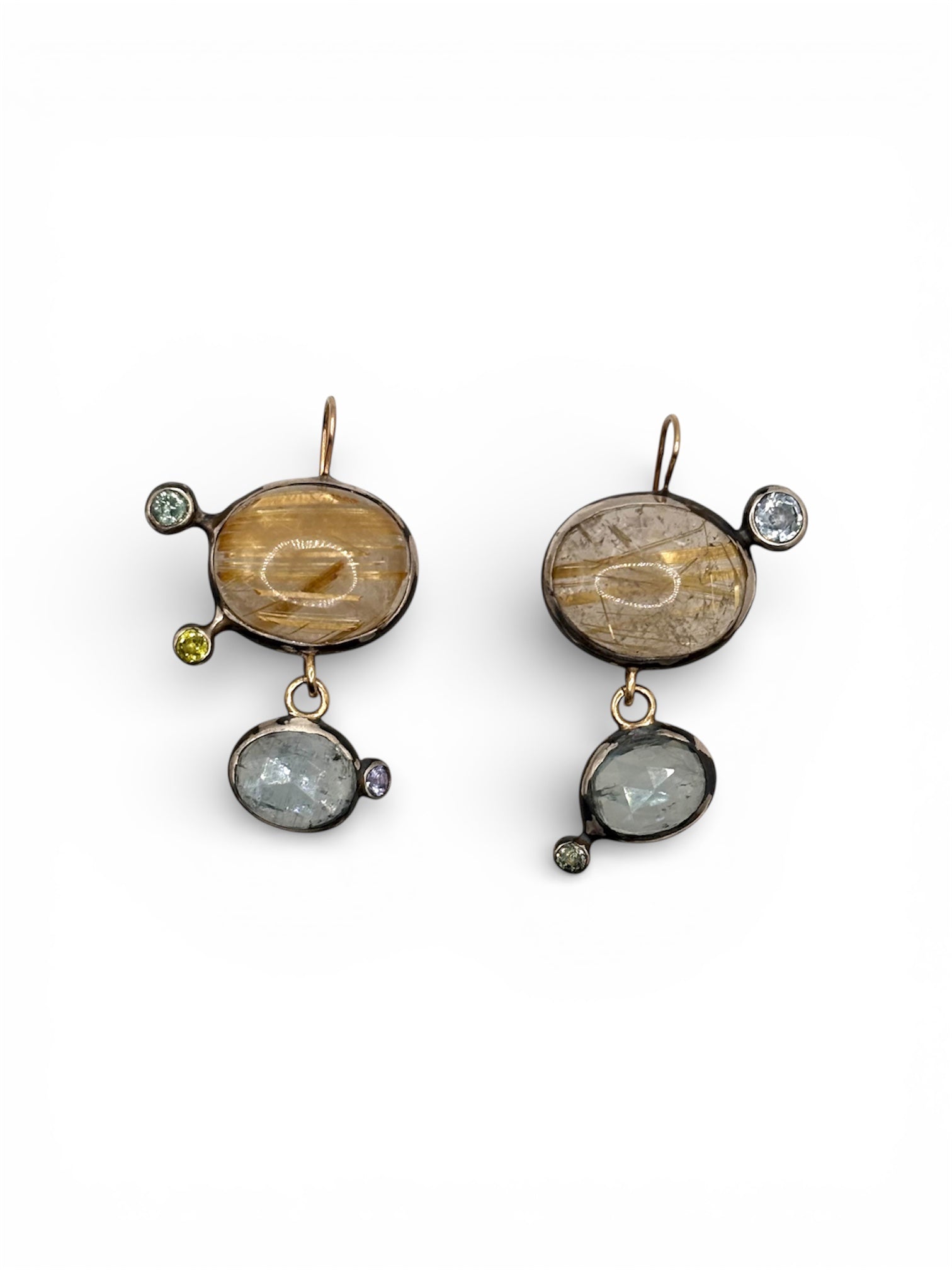 Additional view of Mismatched Asymmetric Rutilated Quartz and Blue Kyanite Dangle Earrings — Gold Rutilated Quartz is contrasting with blue Kyanite and accented with colred sapphires, all set in oxidized silver with affied 14K gold earwire