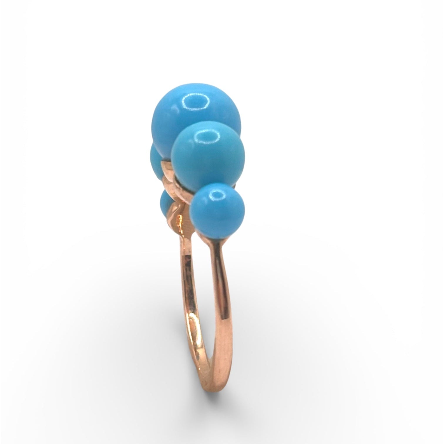 Detail view of Turquoise Gum Ball Gold Ring — Sleeping Beauty Turquoise balls are arranged in 14k rose gold ring setting