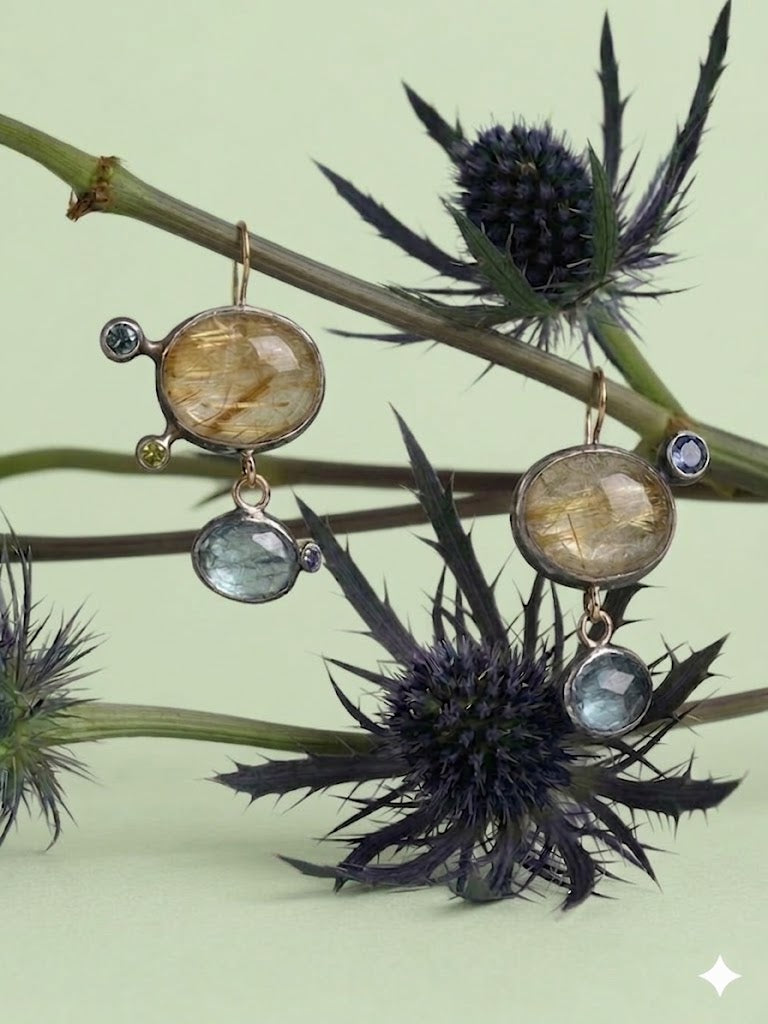 Alternate view of Mismatched Asymmetric Rutilated Quartz and Blue Kyanite Dangle Earrings — Gold Rutilated Quartz is contrasting with blue Kyanite and accented with colred sapphires, all set in oxidized silver with affied 14K gold earwire