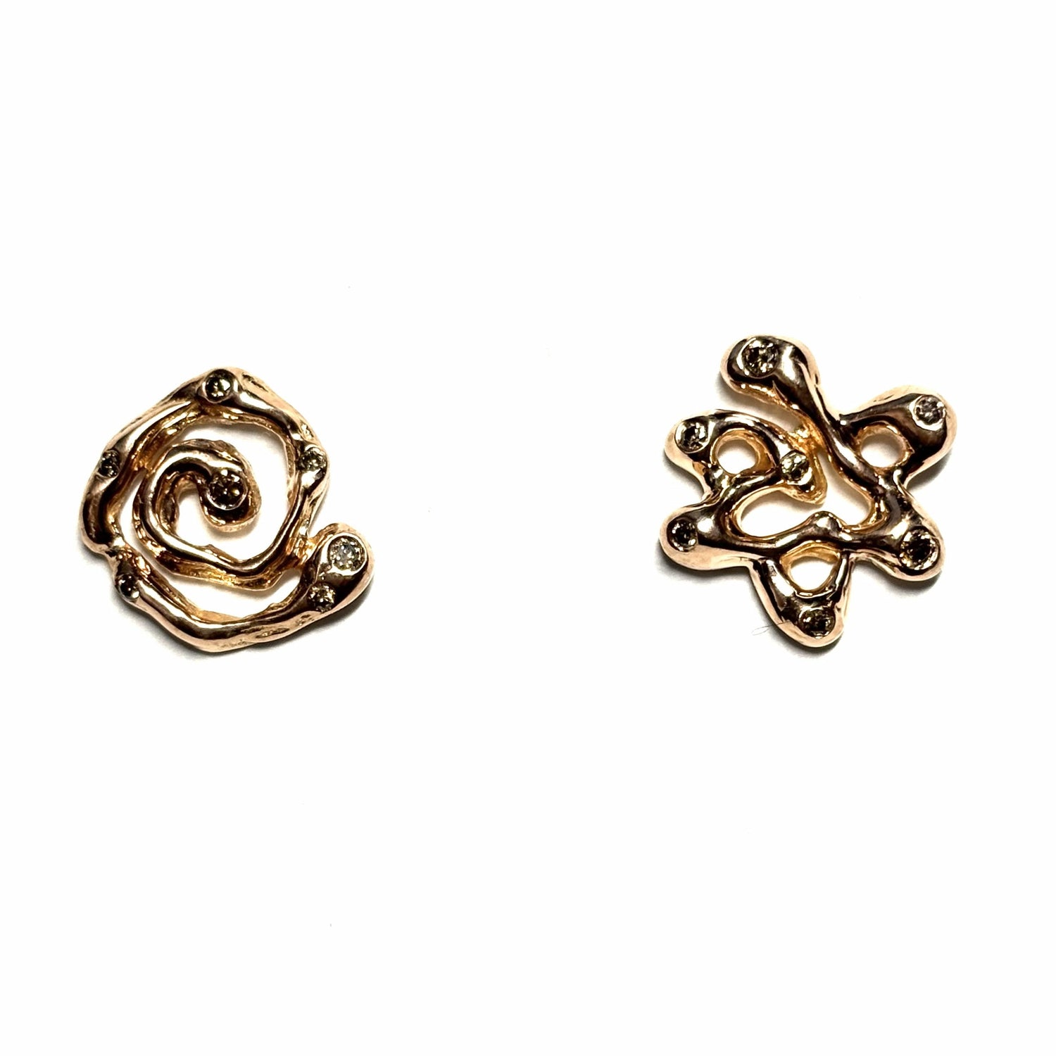 Mismatched Gold Magen David and Swirl Studs with Diamond Accents — Intentionally mismatched, the brand's signature organic